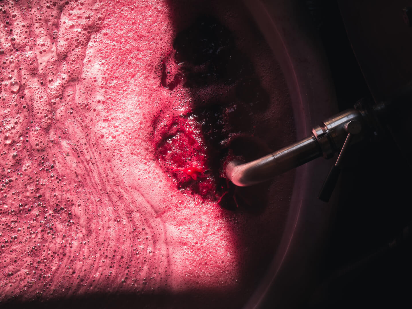 wine being poured into a barrel